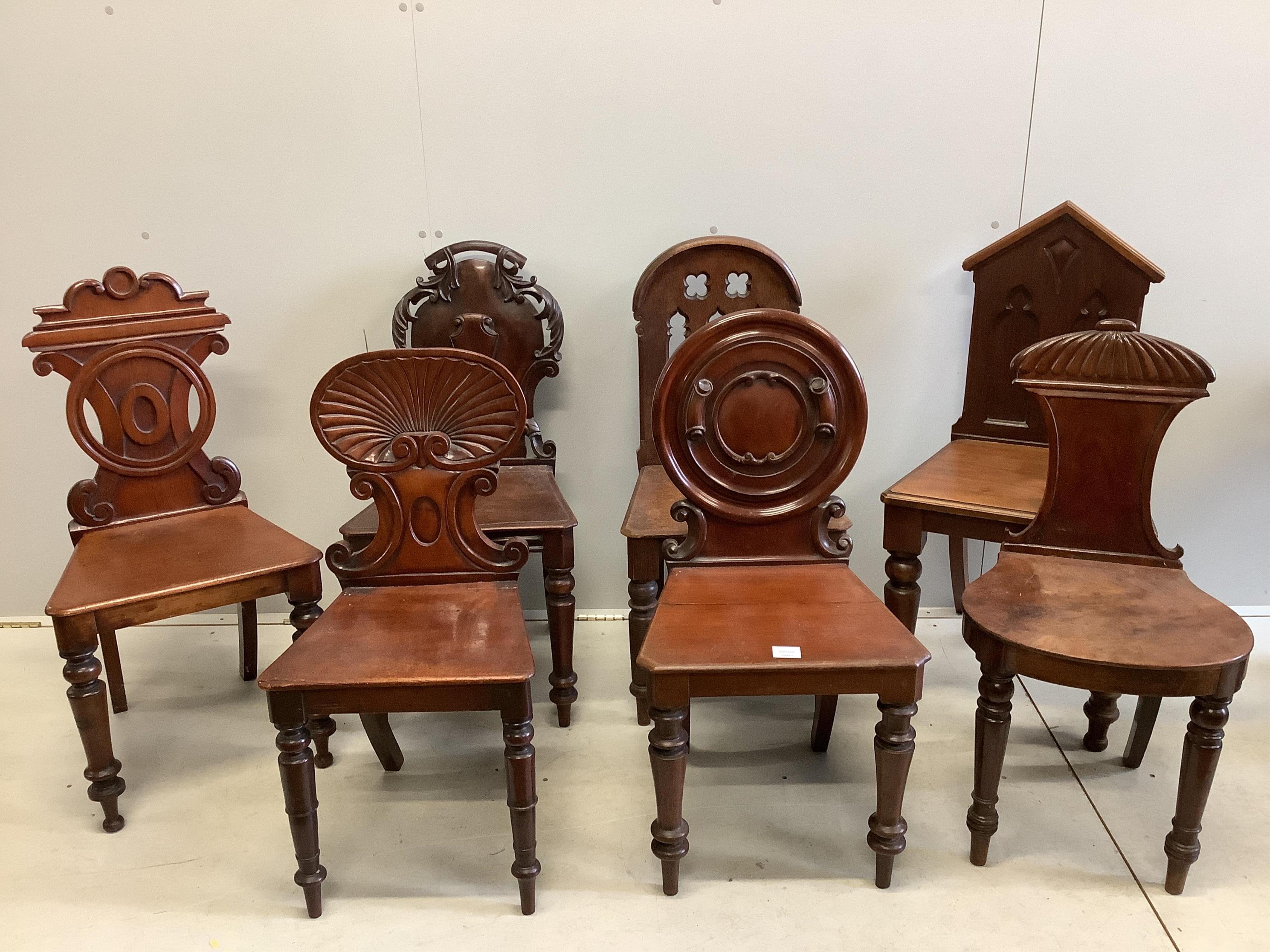 Seven George III and Victorian mahogany and oak hall chairs, largest height 95cm. Condition - fair to good